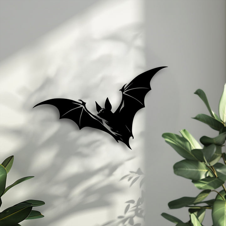 A dynamic flying bat silhouette in black metal creates a sense of movement, casting eerie shadows, making it perfect gothic decoration wall art.