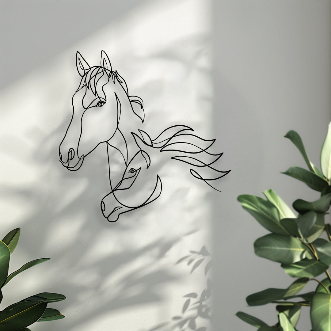 Horizontally oriented metal wall decor featuring an elegant minimalist silhouette of two intertwined horse heads rendered in a single flowing line.