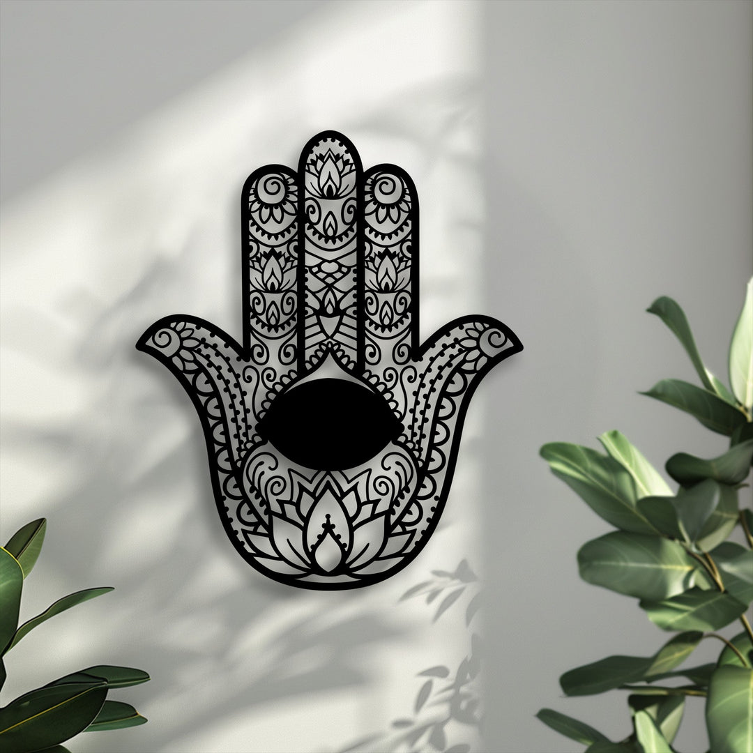 Featuring desaturated tones, this ornamental spiritual Hamsa Hand with Evil Eye metal wall decor showcases intricate patterns against a light wall.