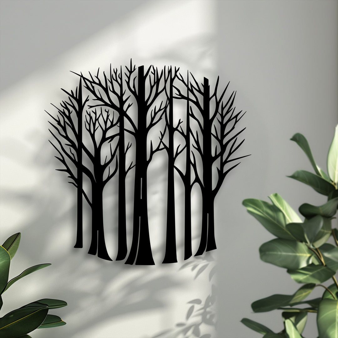 The focal point is black bare trees metal art for wall, depicting elegant tree silhouettes against a light wall with soft shadows.