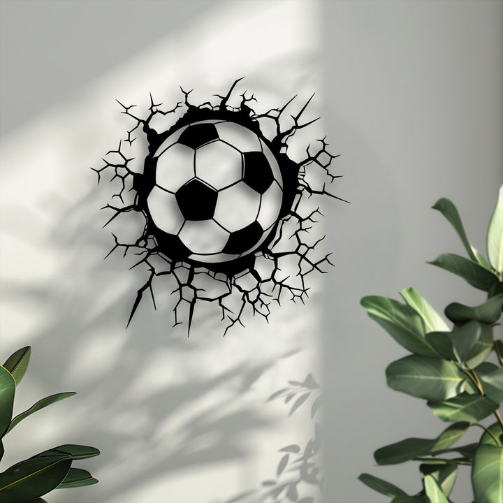 Conveying dynamic movement, this striking decoration wall art features a soccer ball dramatically bursting through a white wall.