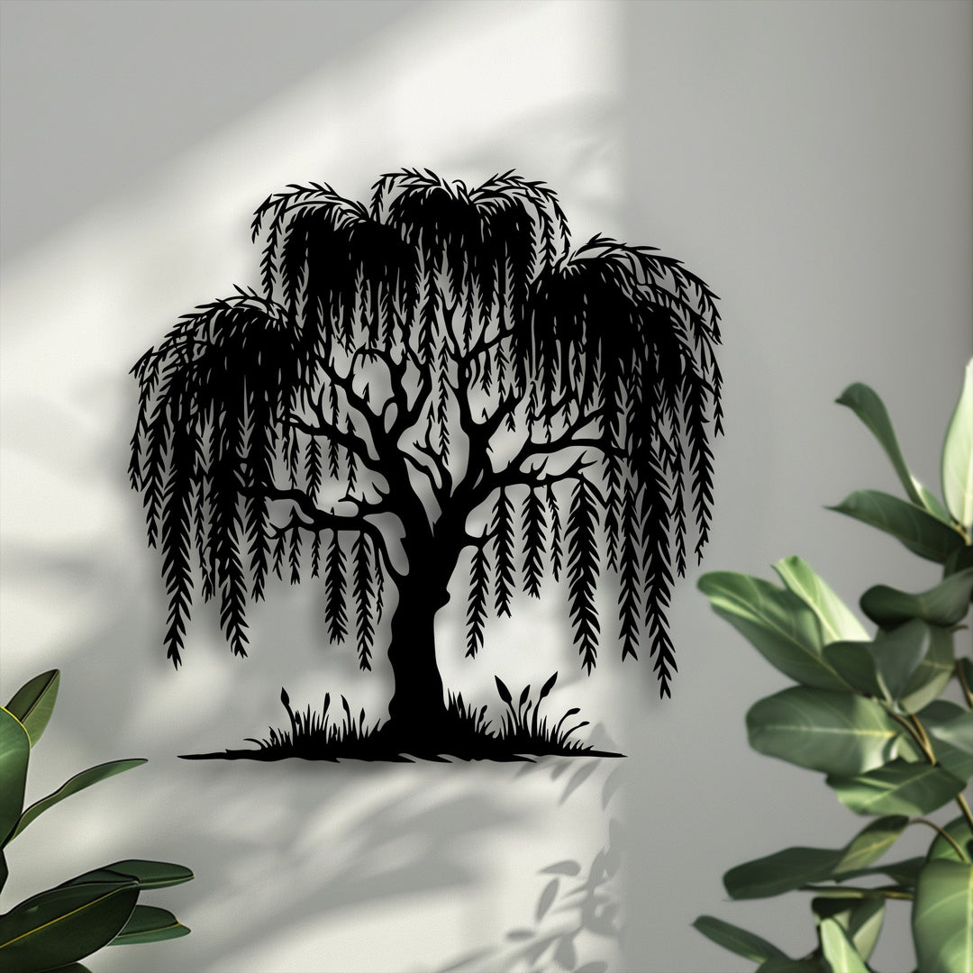 Dramatic light and distinct shadows highlight the elegant Graceful Willow Tree Silhouette decorative metal art, enhanced by subtle plant reflections.
