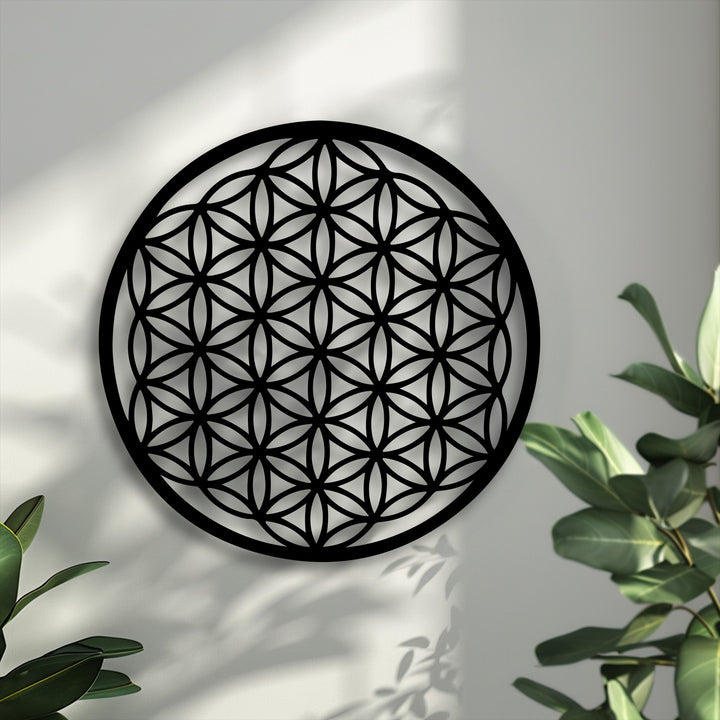 The matte surface texture of this black Flower of Life metal artwork reveals its intricate sacred geometry circle design and crisp shadows.
