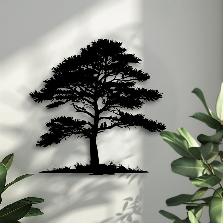 Shifting light creates an ethereal dance of shadows around the detailed Whispering Pines tree silhouette metal artwork, suggesting natural movement.