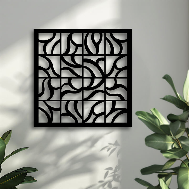 The central subject, a square black geometric decorative metal art piece, showcases intricate abstract flowing patterns.