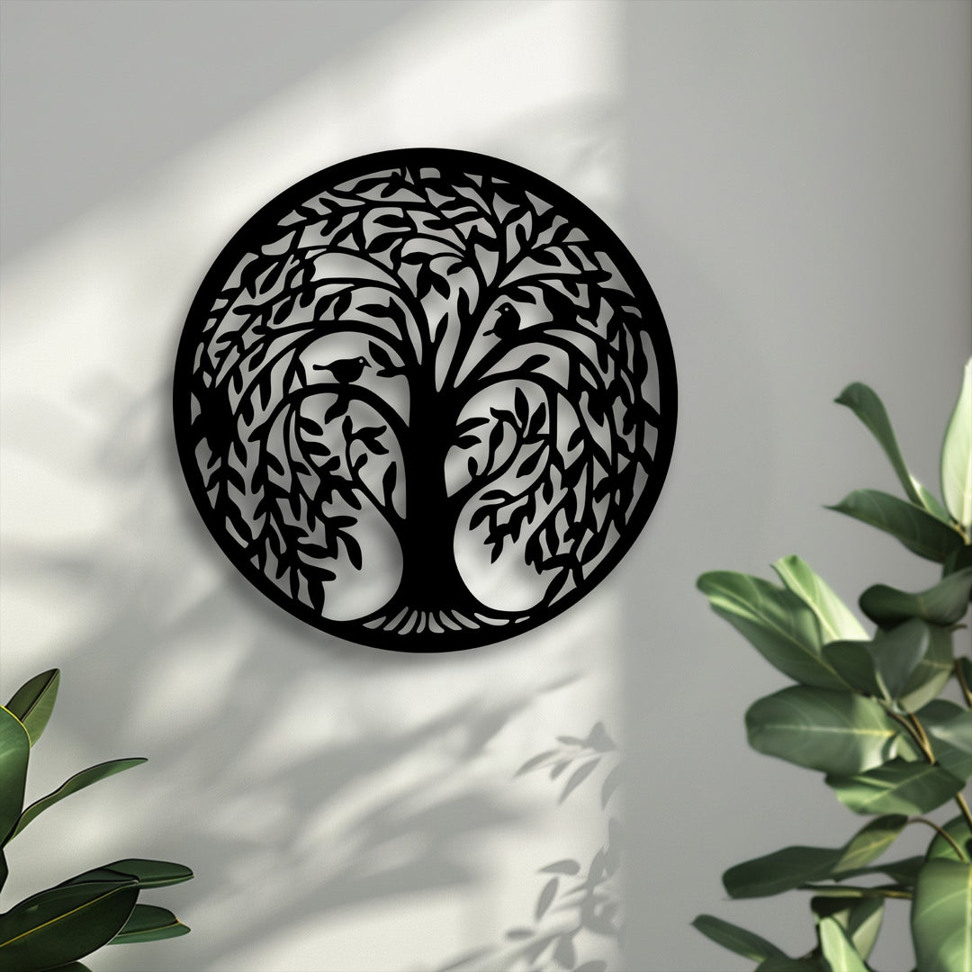 A perfectly circular, Tree of Life metal artwork featuring birds, elegantly centered and casting shadows on a light wall.