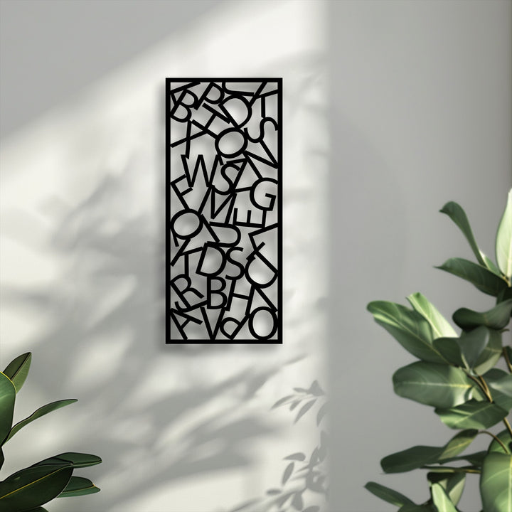 The crisp, cool color temperature enhances the detailed abstract typography metal artwork, showcasing its scattered letter composition on a sunlit wall.