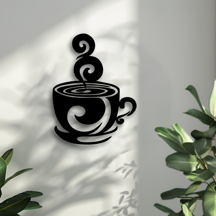 Bold black swirling coffee cup metal art for wall with artistic steam and an elegant design, casting distinct shadows on a bright textured surface.