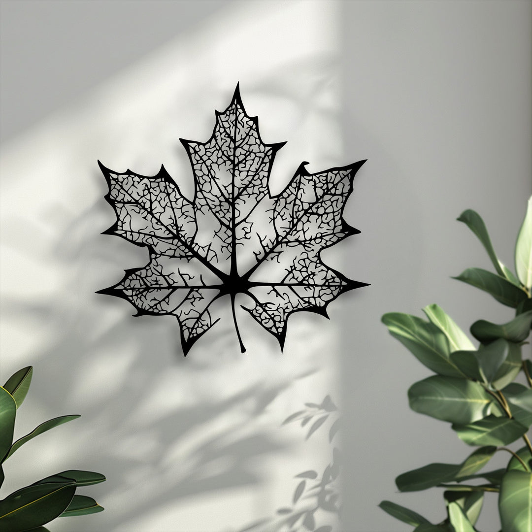 High-quality decorative metal art showcasing an intricate maple leaf silhouette with delicate cut-out veins, displaying superior craftsmanship.