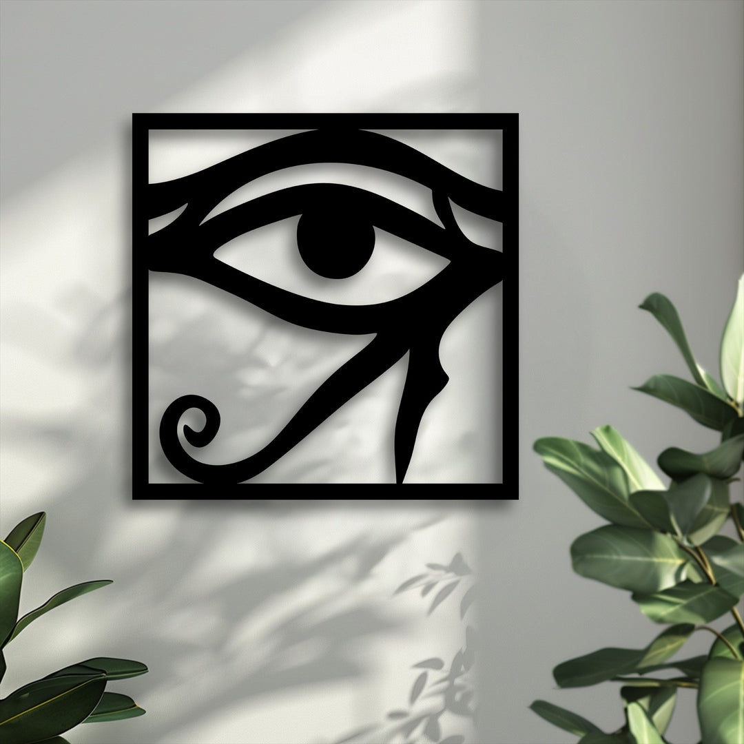 Smooth, dark metal of the Eye of Horus decoration wall art offers a sleek surface against the faintly granular texture of the sunlit white wall.