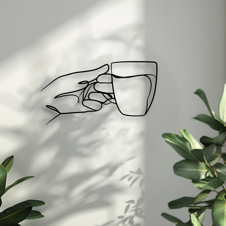 Experience the superior material quality of this unique metal wall art, displaying a minimalist line art hand holding a cup.