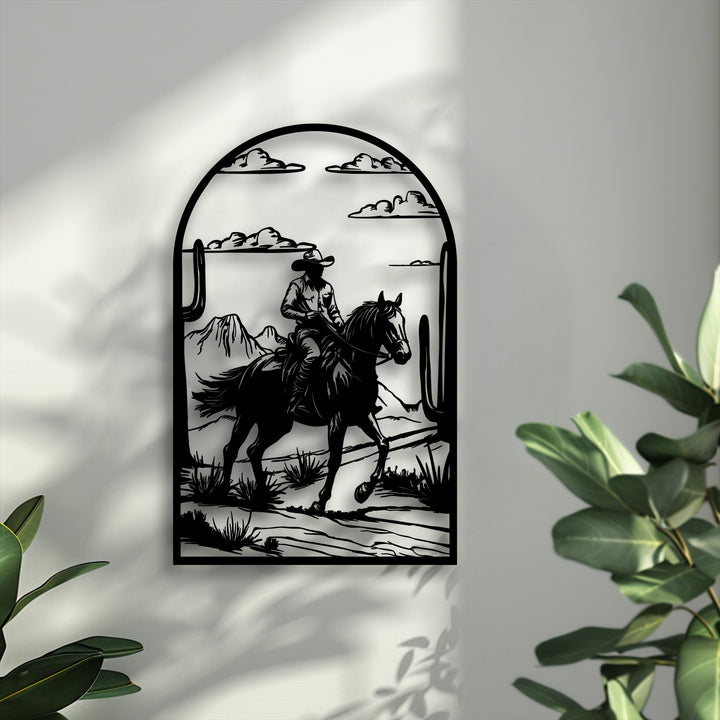 The stillness of a cowboy on horseback traversing a desert landscape is perfectly portrayed in this striking metal wall decor.