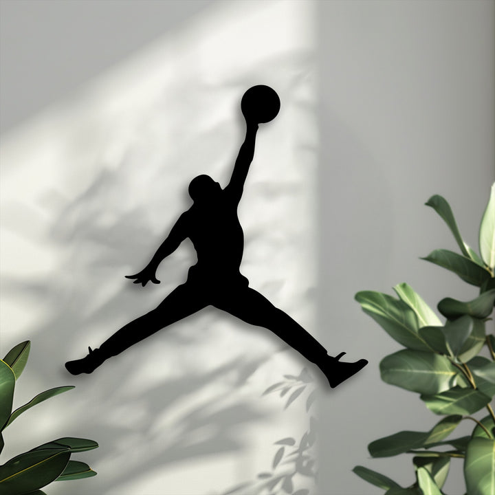 The dominant off-white background features a striking black silhouette of a basketball jump player, a dynamic piece of decorative metal art.