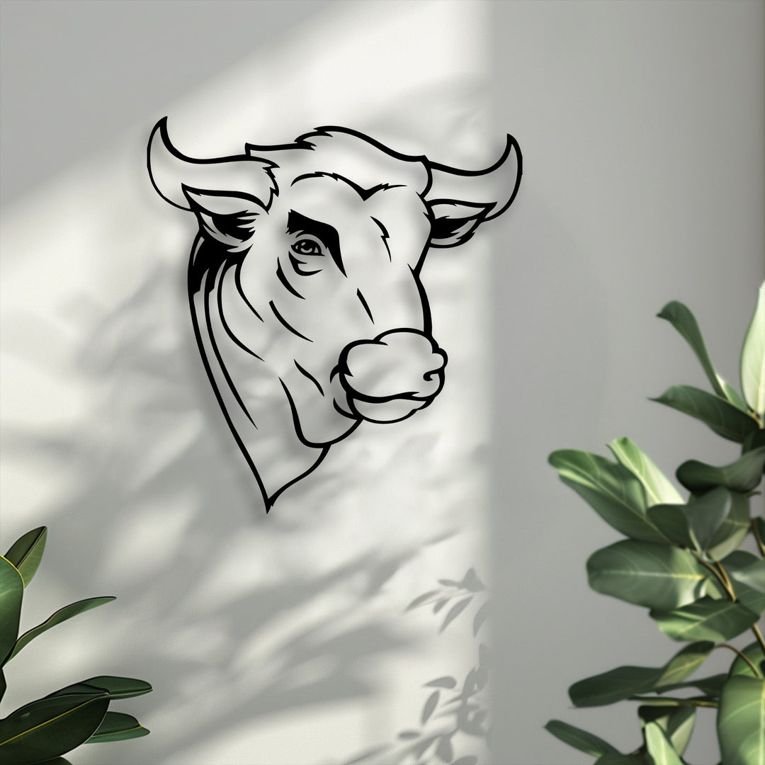 The striking negative space around the rustic bull head metal art for wall highlights its minimal line design against a sun-dappled white wall with plant shadows.