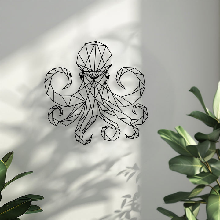 Realistic details like sharp shadows and intricate black lines on the geometric octopus decorative metal art are framed by green plant foliage.