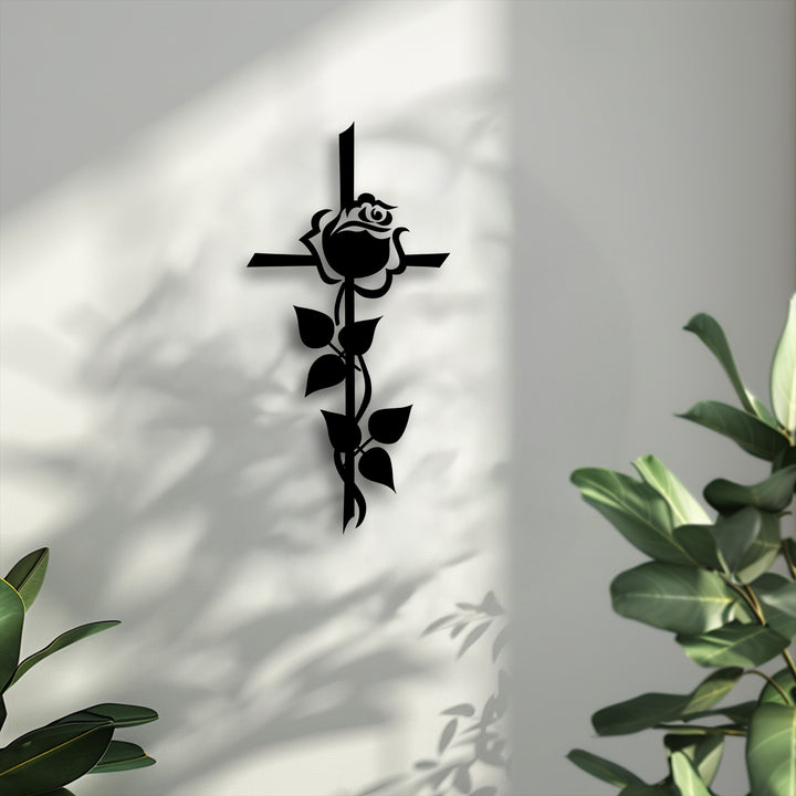 Abstract metal art for wall showcasing a minimalist rose and cross, casting intricate shadows on a bright wall, evokes spiritual contemplation.