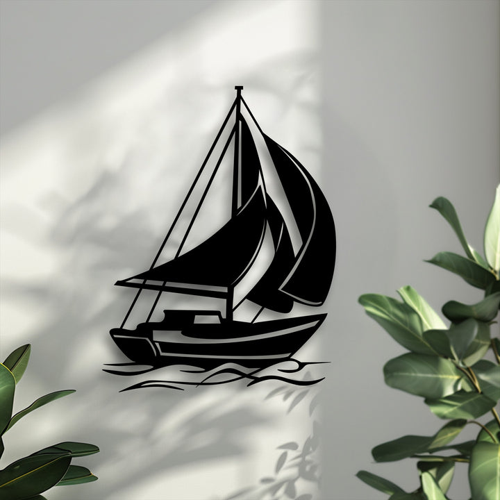Low color saturation emphasizes the bold black sailing boat metal artwork, contrasted by a desaturated grey wall and muted green foliage.