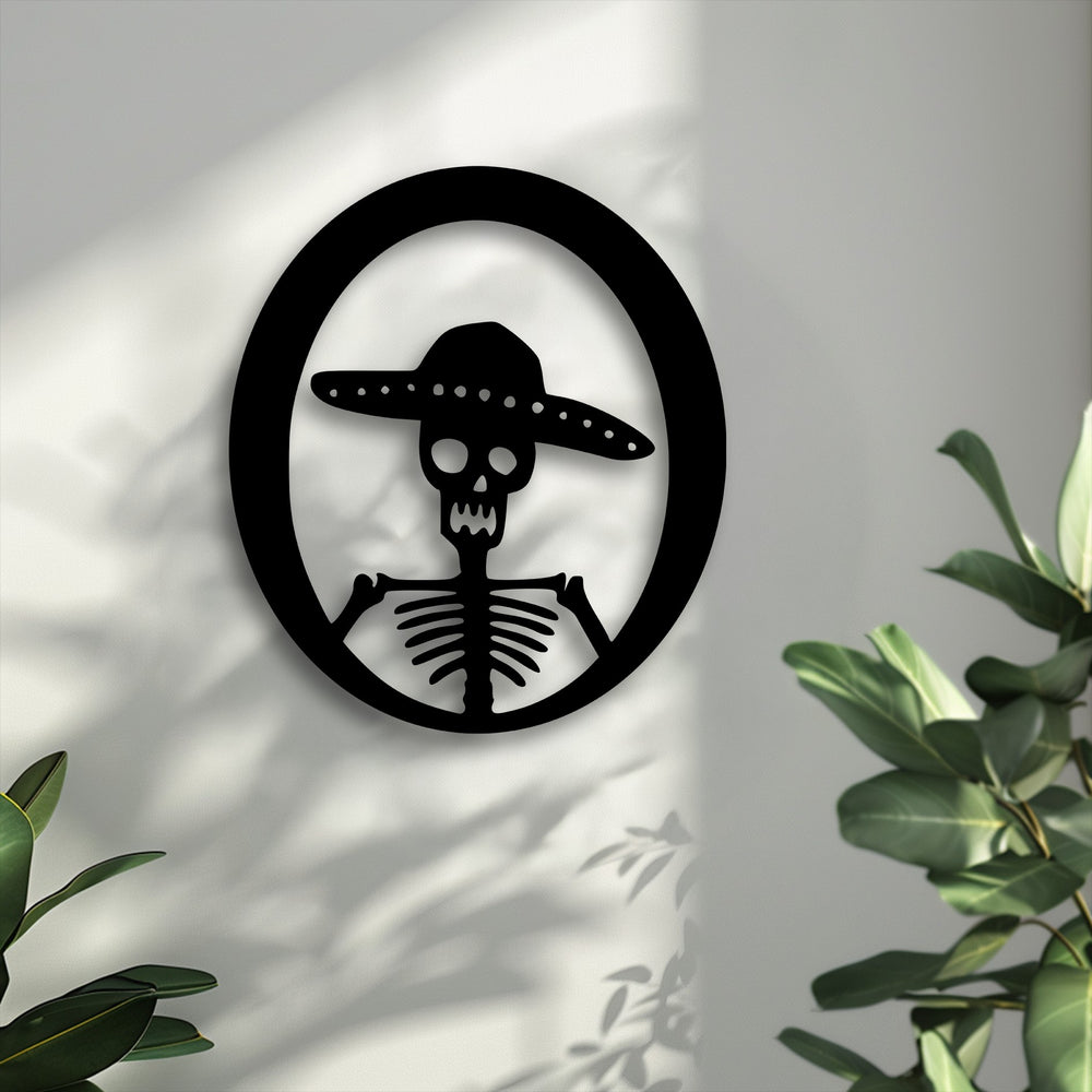 The stark white wall, the brightest area, provides a crisp backdrop for the Sombrero Skeleton Metal Wall Art decoration wall art.