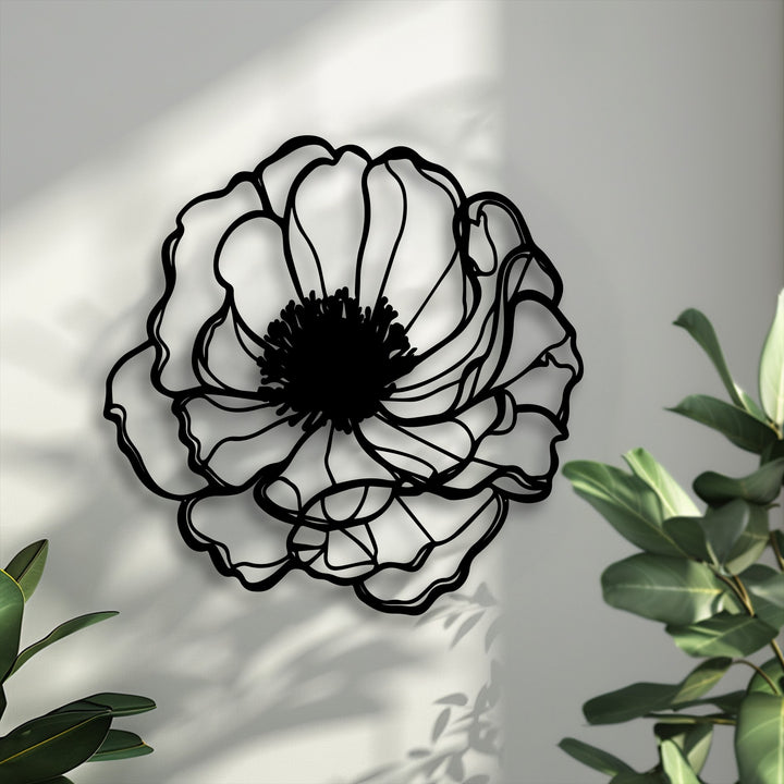 The sleek matte black finish of this minimalist floral metal artwork accentuates its elegant bloom outline.