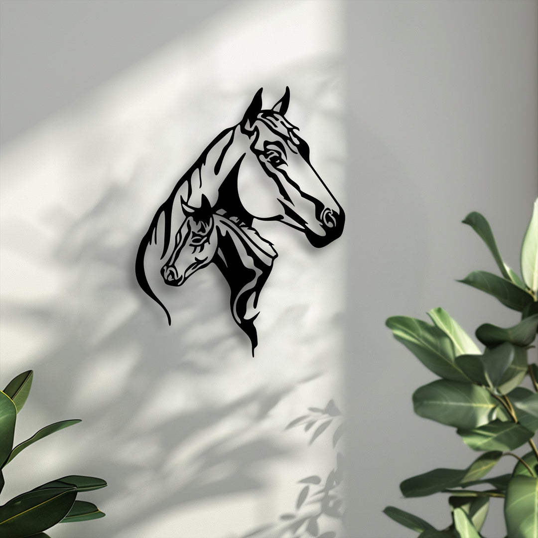 Crisp off-white wall displaying a bold black dual horse head silhouette metal artwork amidst soft shadow patterns.