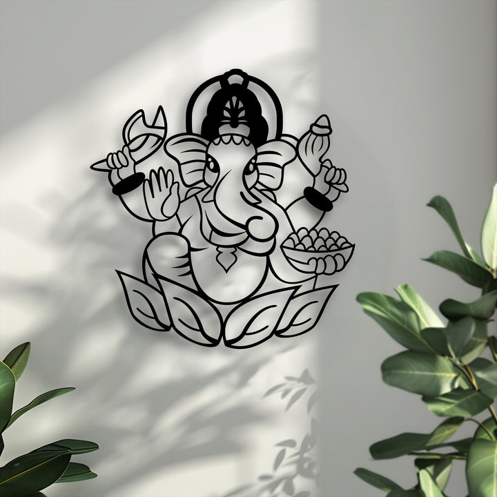 Organic forms flow through the Sacred Ganesha metal wall decor, from the elephant deity on a lotus, beautifully accented by natural plant leaves.