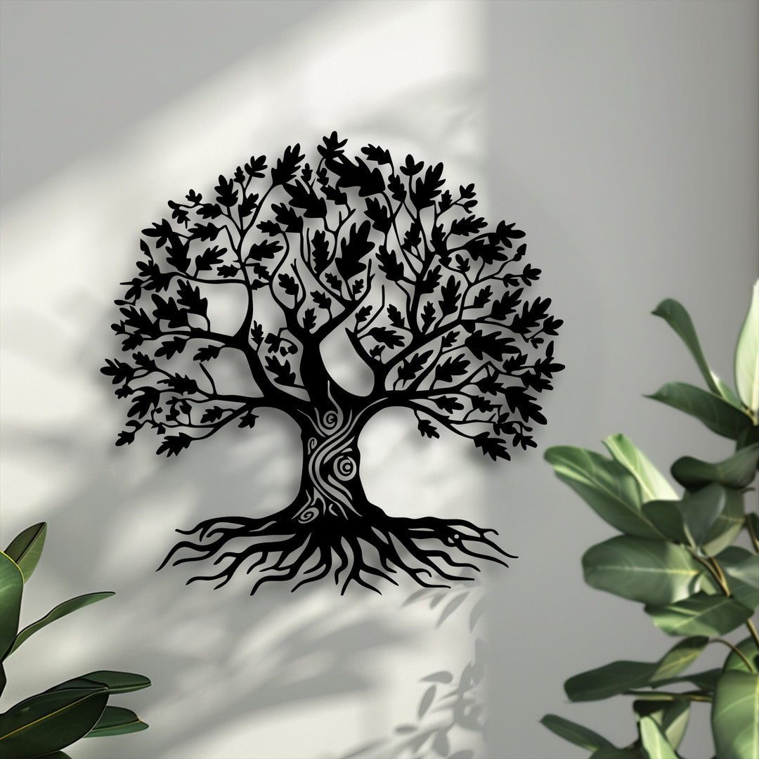 The softest element, the vibrant green foliage, gently frames the symbolic Tree of Life decorative metal art's delicate shadows on the wall.