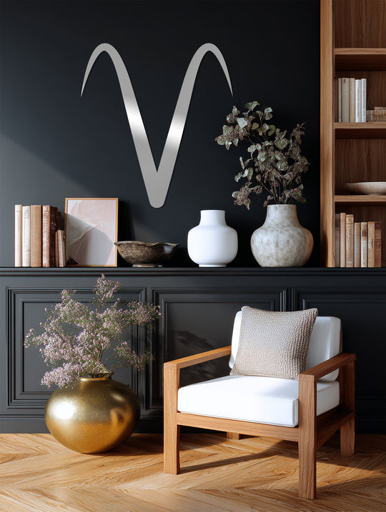 Gleaming, oversized Aries zodiac symbol metal wall decor accents this modern interior, becoming the room's loudest element and reflecting light around the luxurious home decoration.