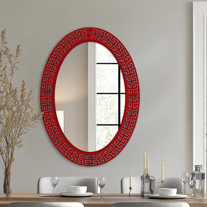 Geometric Greek key patterns define the red frame of this Neo Greco patterned oval floor modern mirror, adding a unique artistic element.