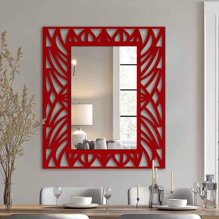 Visual rhythm is established by the square framed wall mirror's red geometric overlay, creating an eye-catching botanical pattern.