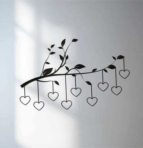 Depths are enhanced by decorative metal art with leaves and dangling hearts, creating layers of romantic charm on a softly shadowed wall.
