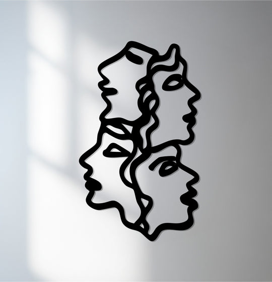 Subtle shadows accentuate the unique metal wall art of the minimalist faces, creating depth and dimension in this unity of faces metal décor.