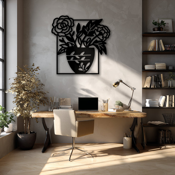 The layering effect of light and shadow highlights the intricate design of the unique metal wall art, a floral vase silhouette.