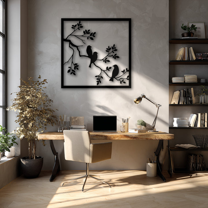 The sleek black frame distinctly borders the unique metal wall art, showcasing a minimal nature silhouette with three birds on branches.