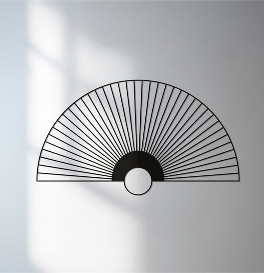 Light and shadow interplay around the unique metal wall art, highlighting the minimalist design of this rising sun fan metal wall art.