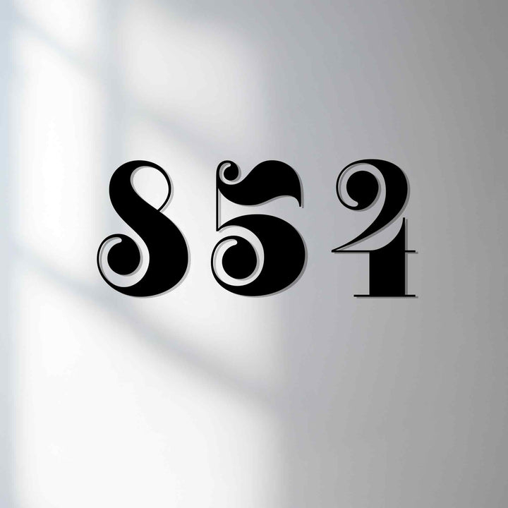 Illuminated backdrop accentuates these vintage style metal house numbers, showcasing a sleek and refined metal wall decor for your home address display.