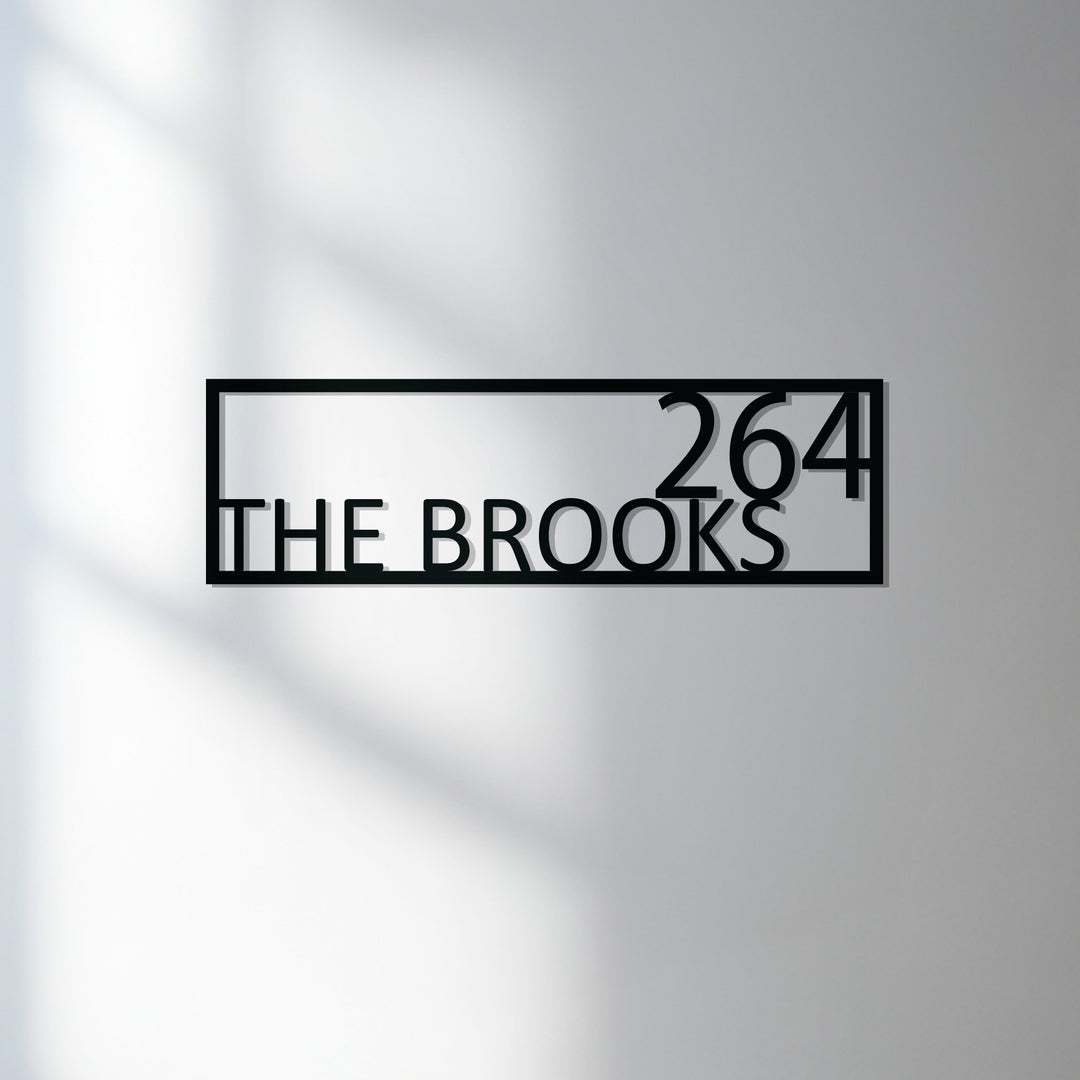 Modern framed metal family name sign exterior