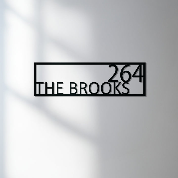 Modern framed metal family name sign exterior