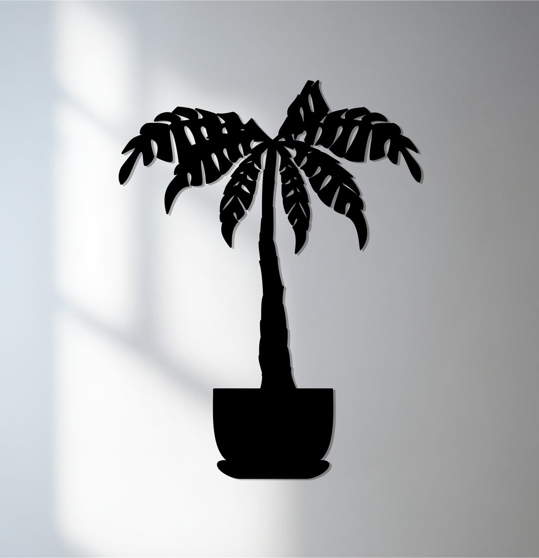 Contrasting shades highlight the sleek, laser-cut edges and smooth, black finish of this tropical palm tree metal art for wall, creating a striking transition between colors.