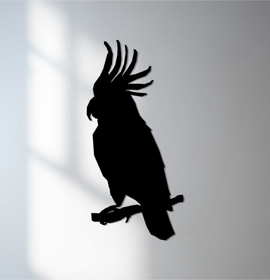 Curving branches and the bird's crest define the organic forms of this parrot metal artwork, a stylized silhouette that offers a unique metal artwork.