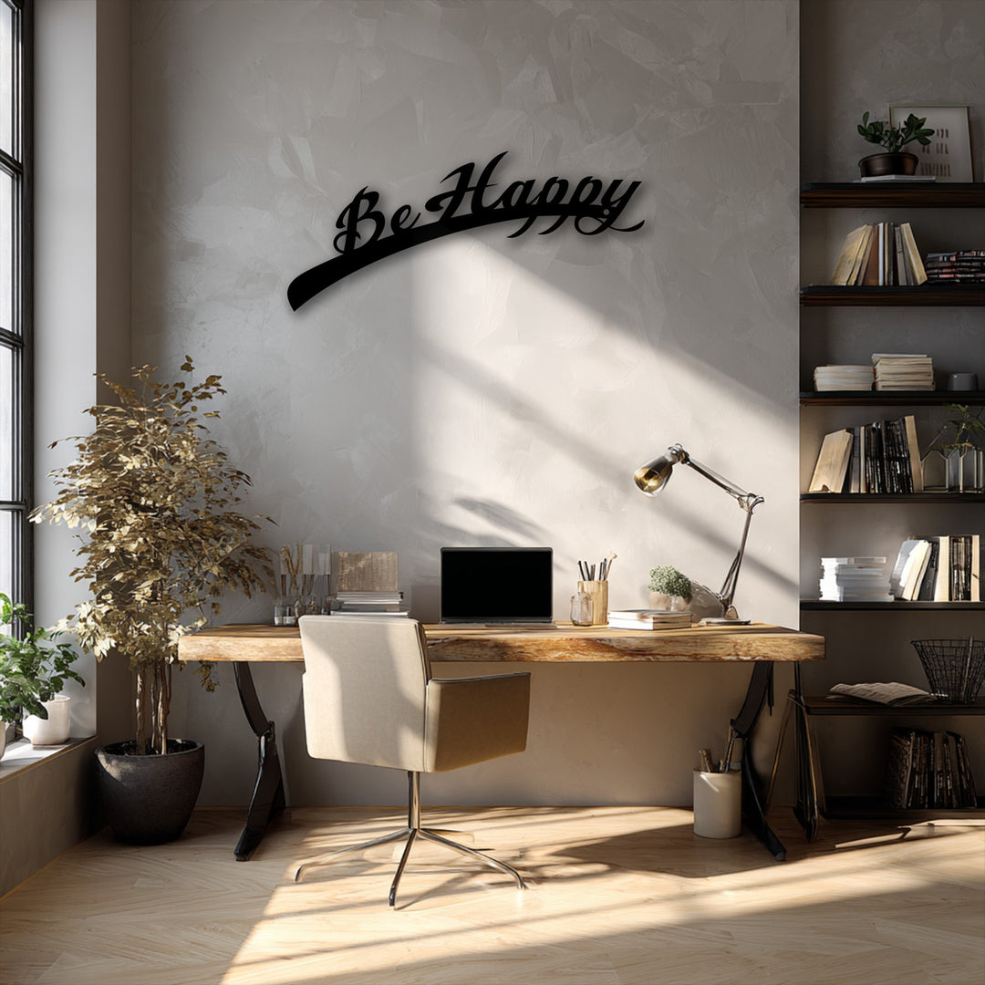 The Be Happy Script metal art for wall is dramatically lit, showing a subtle transition from bright white to soft grey on the textured wall.