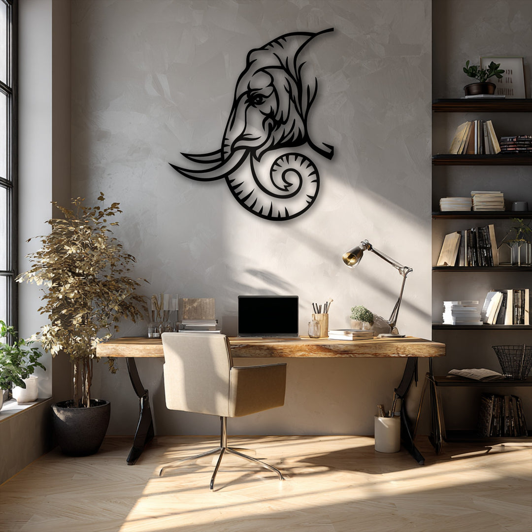 The brightest area illuminates a captivating elephant line art, a decorative metal art piece, elegantly mounted on a textured wall.