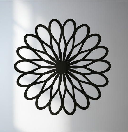 Shifting hues highlight the intricate details of the geometric flower, a captivating metal artwork radiating from a central point with elegant, mandala-inspired petals.