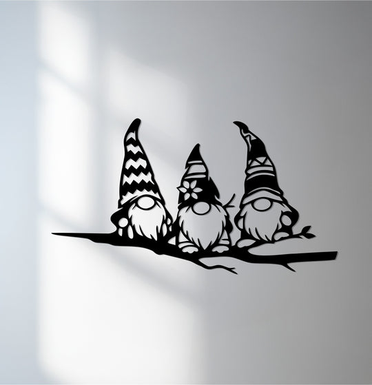 Showcasing the realistic detail, this piece of unique metal wall art depicts a trio of Scandinavian gnomes perched on a branch, creating a charming, whimsical scene.