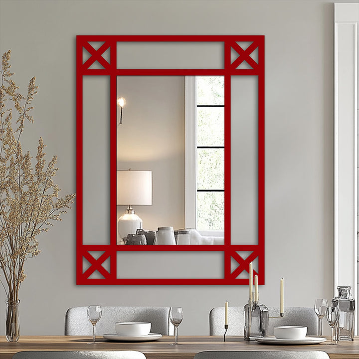 Highlighting the realistic detail of the reflection in this modern mirror, a red framed minimal cross detail mirror adds a chic touch to a dining room setting.