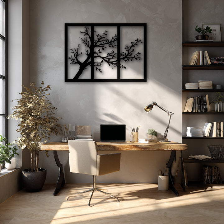Textured concrete walls and a rough wooden desk highlight the smooth, matte finish of the minimalist tree silhouette metal artwork.