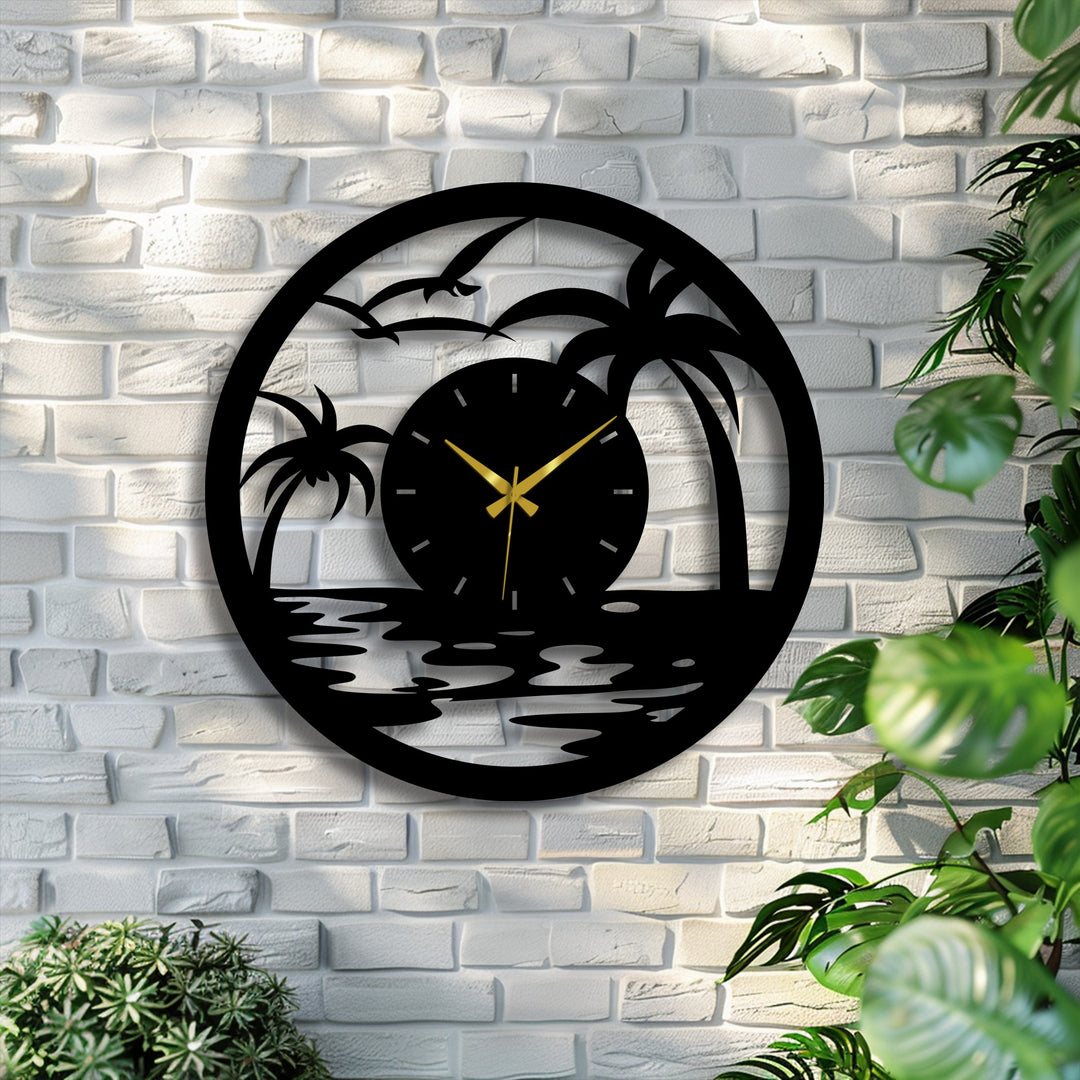 Circular tropical sunset metal wall clock featuring unique metal wall art hangs horizontally against a white brick wall with surrounding plants.