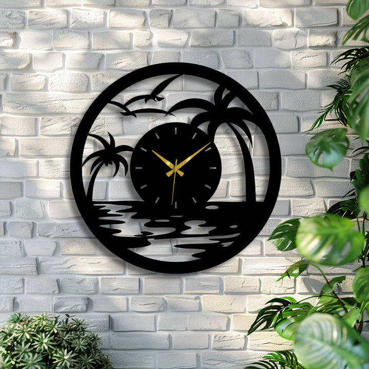 Circular tropical sunset metal wall clock featuring unique metal wall art hangs horizontally against a white brick wall with surrounding plants.