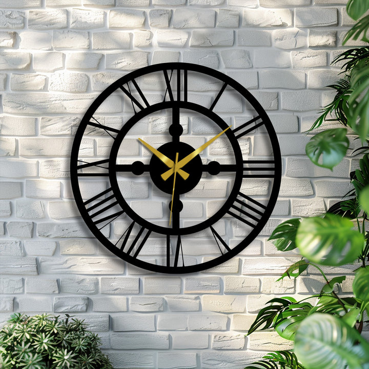 Intertwined with organic forms, a black Industrial Roman Gear Metal Wall Clock contrasts against the brick wall with surrounding plants as metal artwork.
