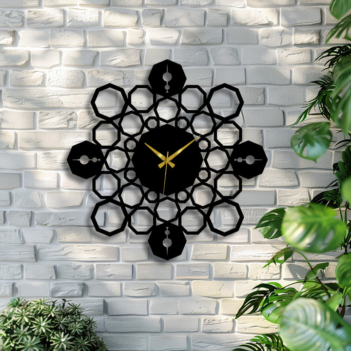 The darkest area, a striking black geometric mandala metal art for wall, displays golden hands at its center against a textured white brick wall.