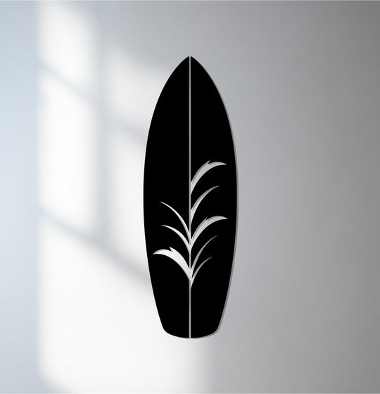 Smooth surface texture defines this unique metal wall art, showcasing a tropical surfboard with an intricate, embossed leaf design.